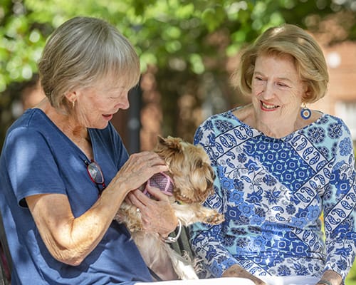 women smiling with dog