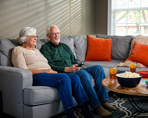 couple watching TV with popcorn