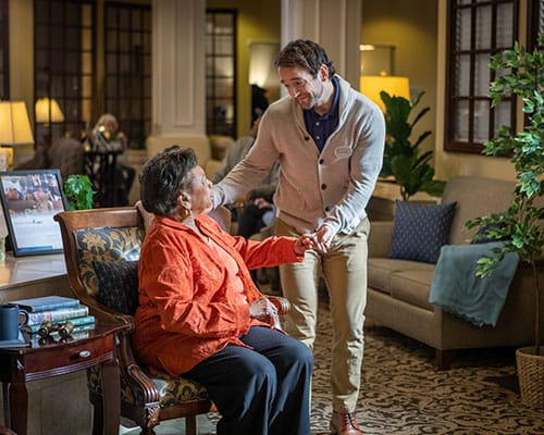resident showing caregiver something on phone