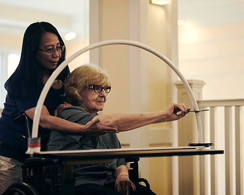 caregiver helping resident with a memory care activity