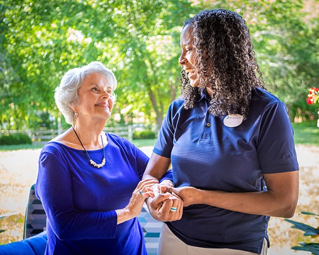 caregiver helping resident walk