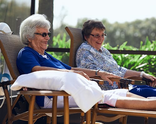 women sitting in lounge chairs