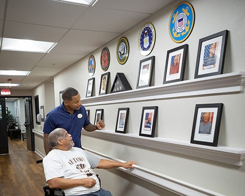 caregiver pushing resident in wheelchair