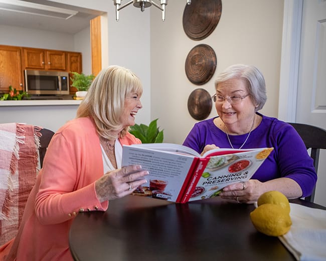 friends looking at cookbook