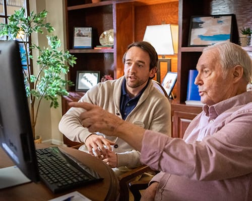father and son looking at computer