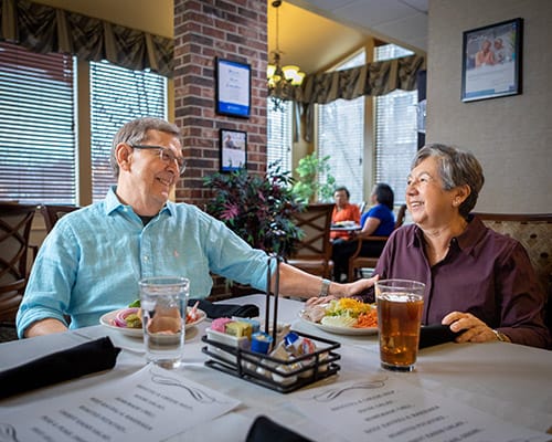 caregiver serving drinks to couple