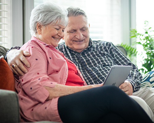 couple sitting with tablet