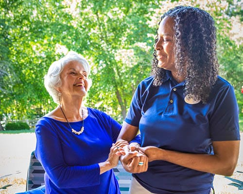 caregiver helping resident stand