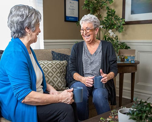 caregiver serving drinks to couple