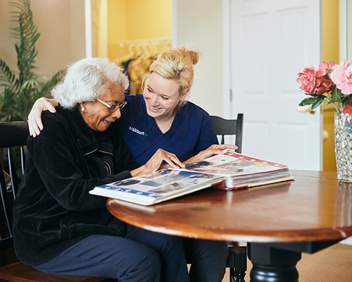 caregiver and resident scrapbooking together