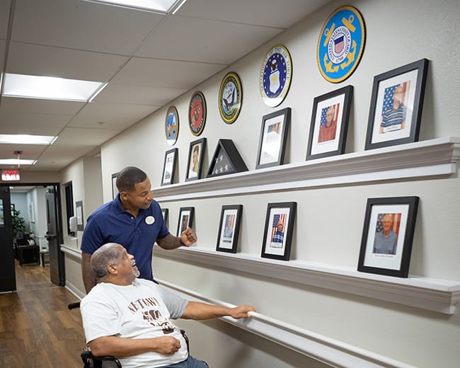 caregiver and man on walking path outside