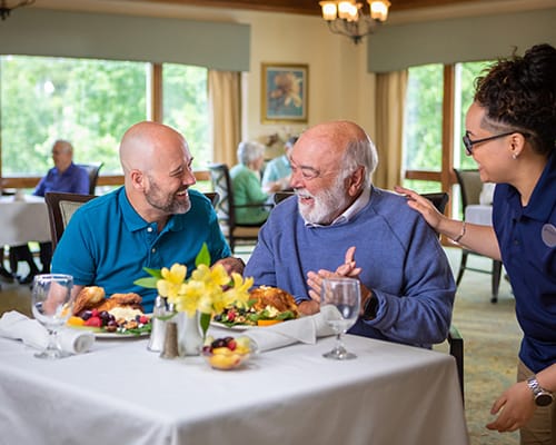 caregiver and resident looking out window