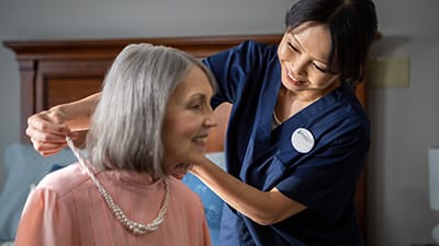 helping woman with necklace