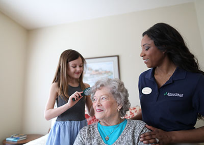 Brookdale resident with granddaughter and caregiver