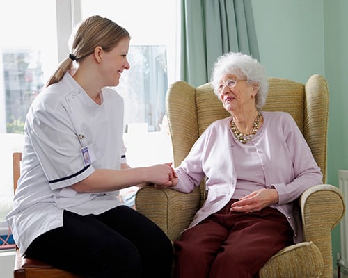 nurse and woman in chair