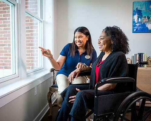 Associate and woman looking out the window