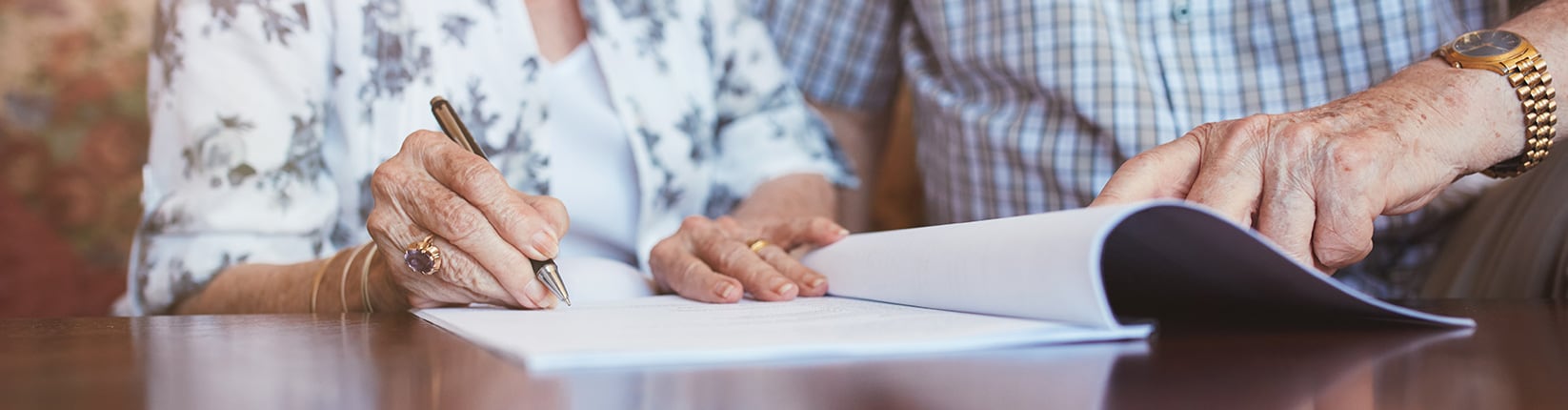 couple signing paperwork
