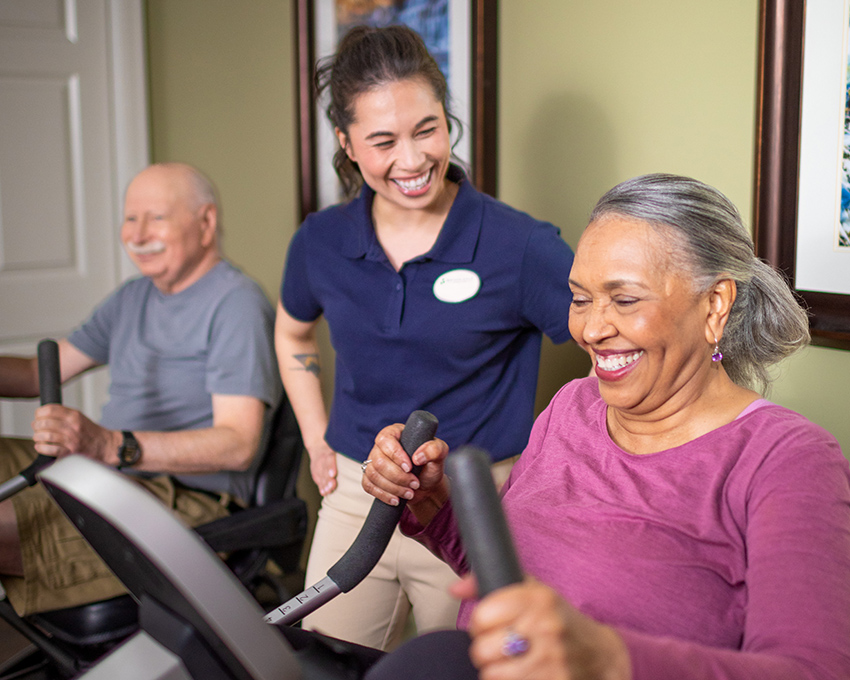 Caregiver helping resident with exercise