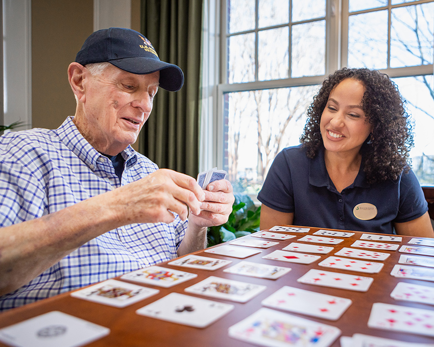 Caregiver playing game with resident