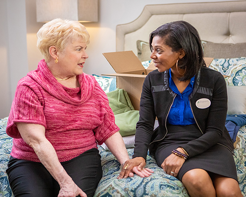 Caregiver talking with resident