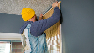  Team member hanging up curtains