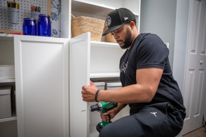  Team member installing cabinets 